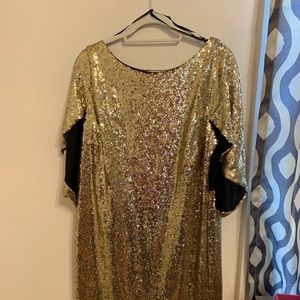 Gold sequined ELOQUII cape dress.